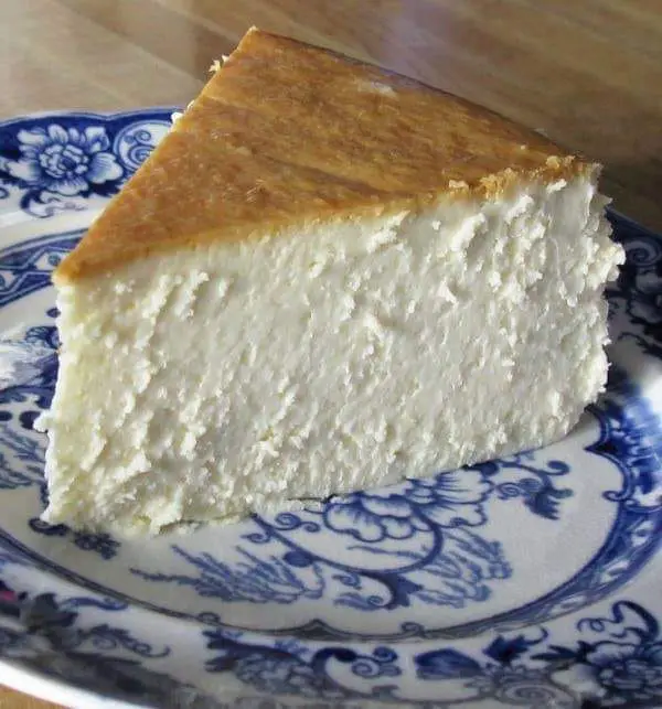 cream cheese, sugar, eggs, and vanilla extract, set on a graham cracker crust